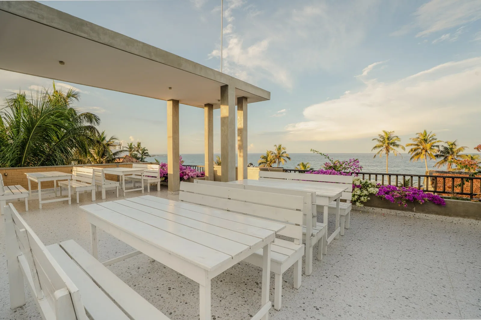 Rooftop terrace seating with ocean and palm views at Bliss Blessings Villa & Spa